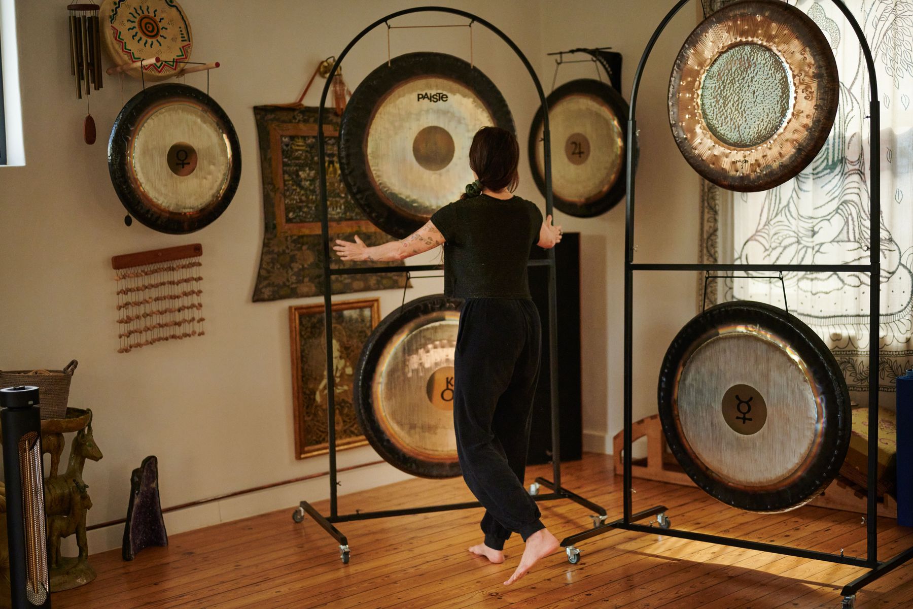 A player moves between stands of Paiste gongs in the ShangriLa studio